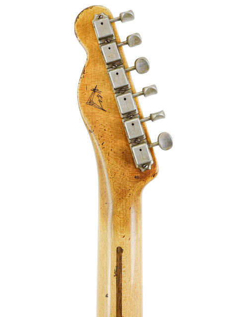 Detailed view of a guitar neck with a wooden headstock, highlighting the Fender Custom Shop 70th Anniversary Nocaster model.