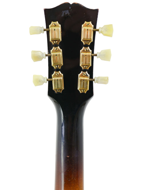 Detailed view of the headstock on a 1952 Gibson J-185 guitar, showcasing a beautiful gold tone and vintage craftsmanship.