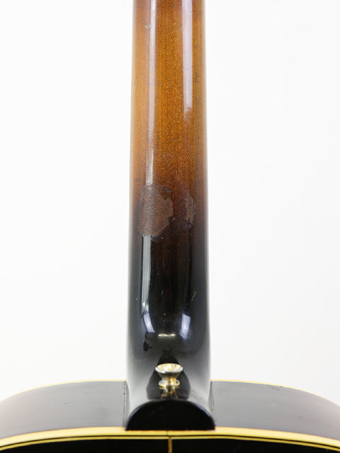 Detailed view of the neck of a 1952 Gibson J-185 acoustic guitar, highlighting its vintage craftsmanship and elegant finish.