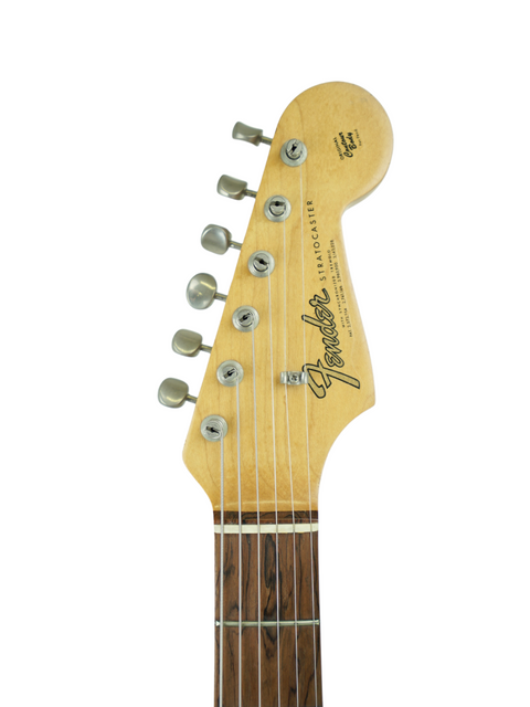 Detailed view of the neck of a 1965 USA Fender Stratocaster electric guitar, highlighting its vintage design and features.