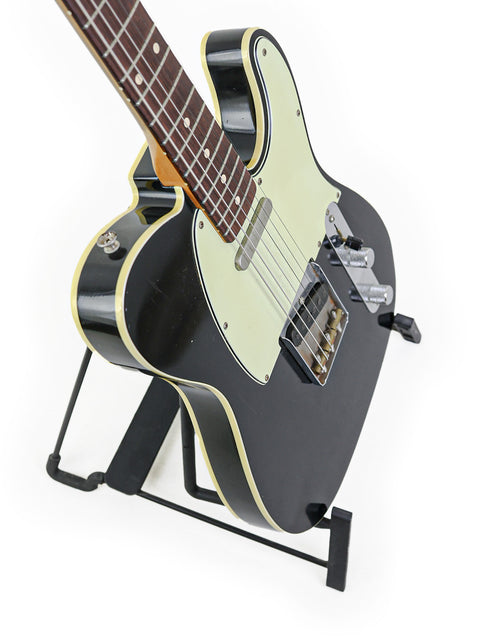 Fender '59 Custom Telecaster in black on a stand, set against a bright white background.