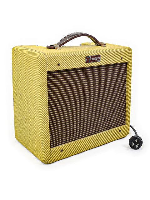Yellow guitar amplifier, Fender Custom Shop '57 Champ Combo from 2009, featuring a brown handle for easy transport.