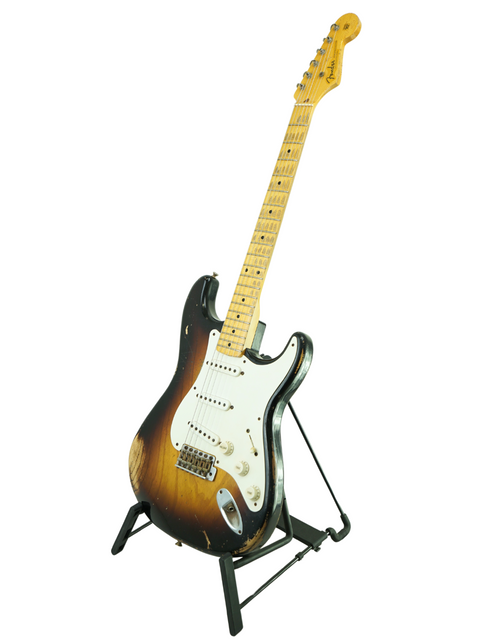 Fender Custom Shop 60th Anniversary '54 Stratocaster Relic guitar elegantly positioned on a stand with a white backdrop.