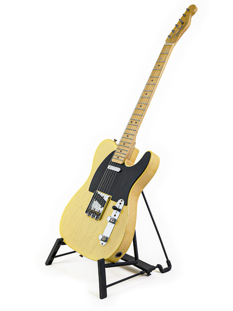 Fender Custom Shop 70th Anniversary Broadcaster guitar elegantly positioned on a stand with a white backdrop.