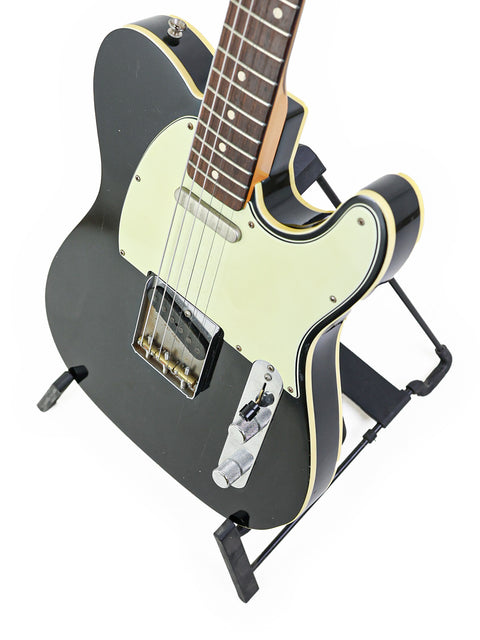 Fender Telecaster guitar in black with a white pick guard, a 2006 NRG Special Release by John English Master Built.