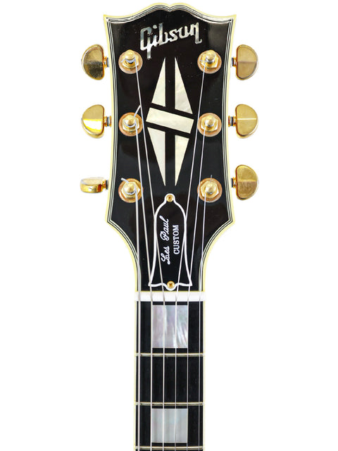 Gibson ES-335 guitar, a popular choice among musicians, showcased alongside a 2006 Gibson Custom Shop Les Paul Custom.