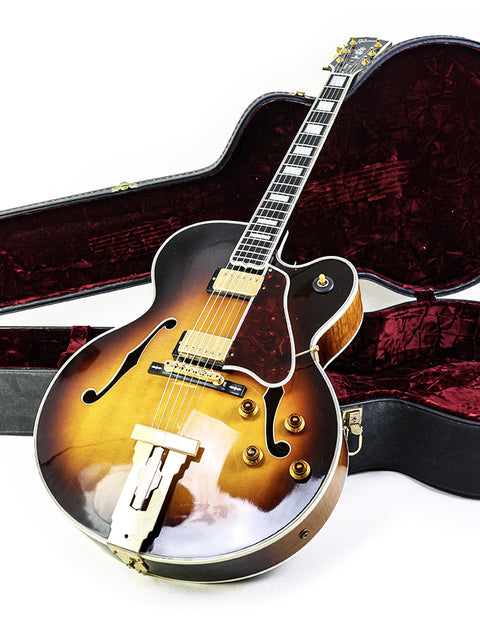 Gibson L-5 CES guitar in a case, elegantly displayed on a clean white background, showcasing its classic design.