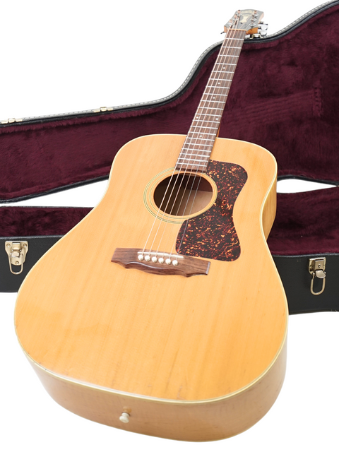 Guild D030A07 Dreadnought guitar with case on a white background, perfect for musicians seeking quality and style.