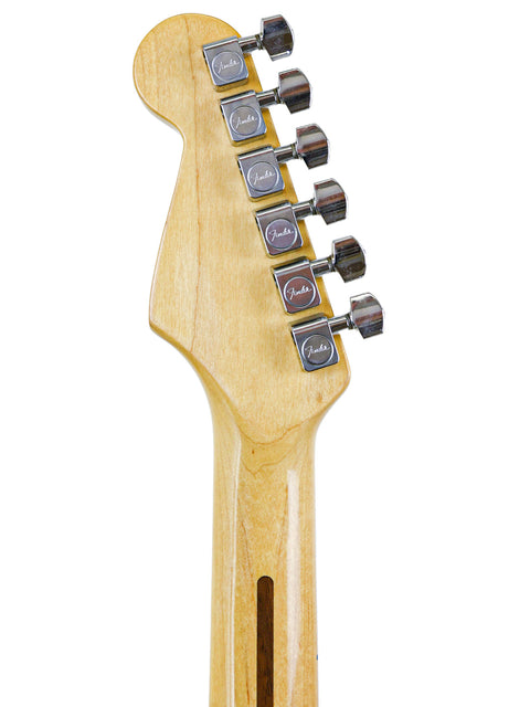 Headstock of a guitar with tuning pegs, isolated on white background.