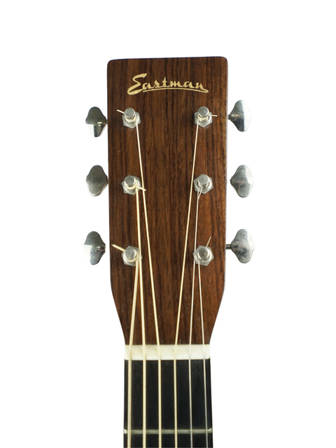 Headstock of an Eastman guitar with tuning pegs and strings on a white background.