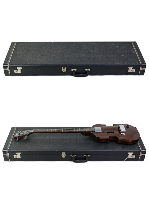 Inside a case, a vintage 1969 Gibson EB-1 guitar and another instrument rest side by side, ready for performance.