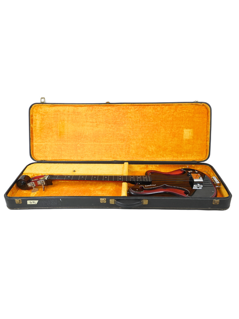 Inside a guitar case, a 1966 Vintage Ampeg AEB-1 electric bass guitar rests, highlighting its retro charm.