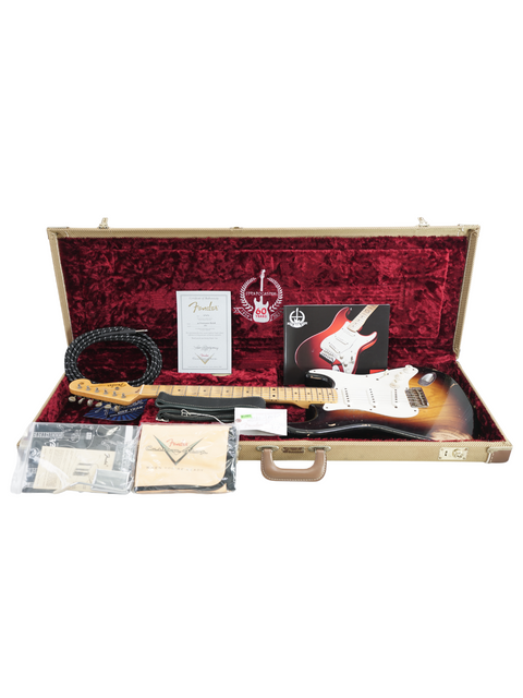 Inside a guitar case, a Fender Custom Shop '54 Stratocaster, strings, and accessories, marking the 60th anniversary edition.
