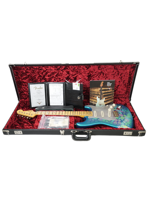 Inside a guitar case, a blue Fender Custom Shop EL Diablo Strat guitar is displayed elegantly.