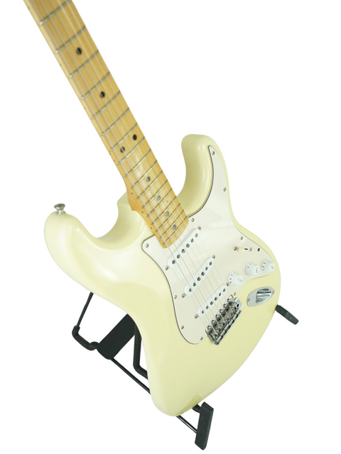 Limited edition white electric guitar on a black stand, featuring the Fender Custom Shop Masterbuilt design from 2006.