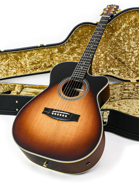 Maton EBG808C 'Nashville' guitar alongside its case, both displayed on a pristine white background for a striking visual.