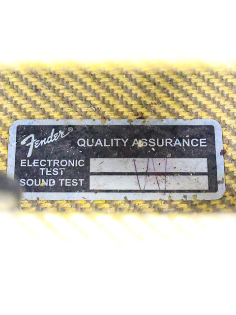 Quality assurance sticker from Fender on a 2009 Custom Shop '57 Champ Combo guitar, signifying high standards in production.