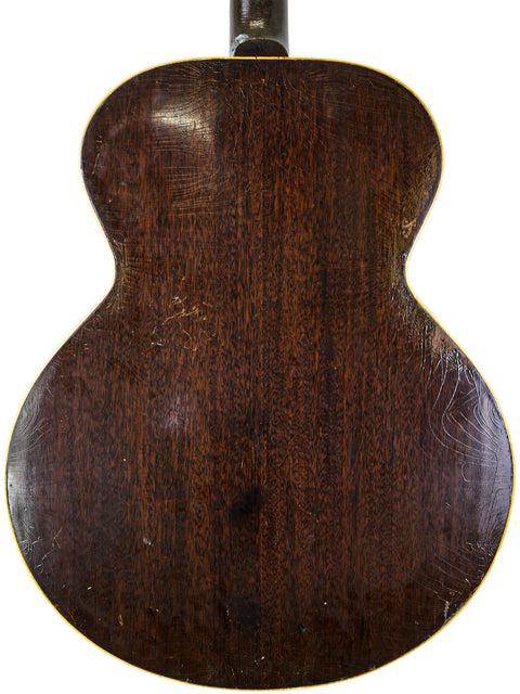 Rear perspective of a 1930s Gibson J-45, highlighting its vintage appeal and intricate details.