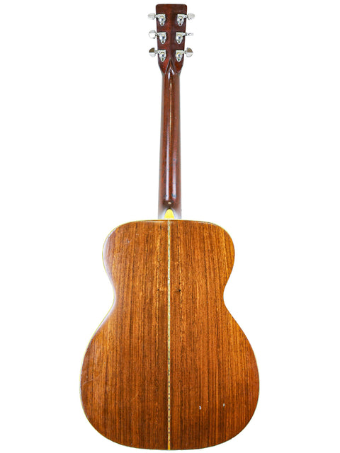 Rear perspective of a 1974 Martin 000-28 acoustic guitar, featuring a beautifully crafted wooden back.