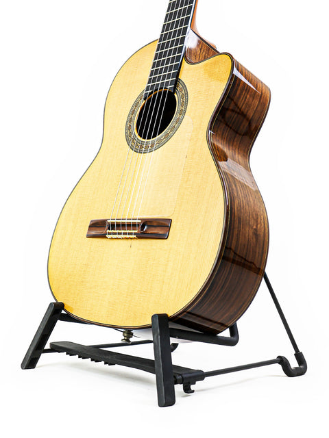 Robin Moyes Custom guitar from Australia, 2002, elegantly displayed on a stand against a clean white background.