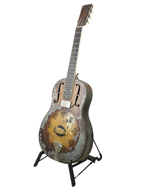 Rustic 1930 National Triolian guitar on a stand, highlighting its vintage charm and unique character.