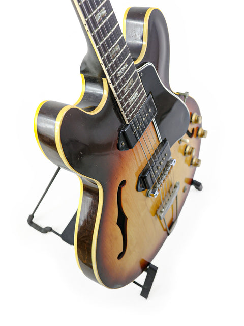 Stunning 1964 Gibson ES-330TD guitar showcasing a black body paired with a bright yellow neck.