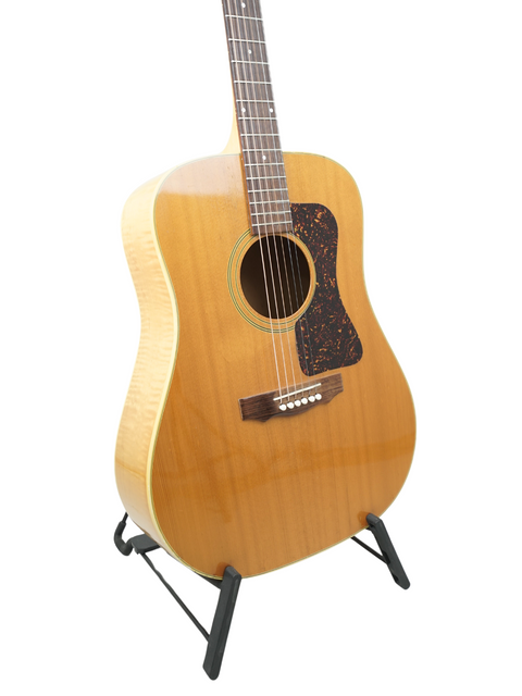 Stunning 1987 Guild D030A07 Dreadnought guitar displayed on a stand, perfect for musicians and collectors alike.