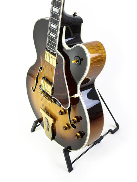 Stunning Gibson L-5 CES guitar from 2002, featuring a sleek black body and rich brown neck, perfect for any music lover.