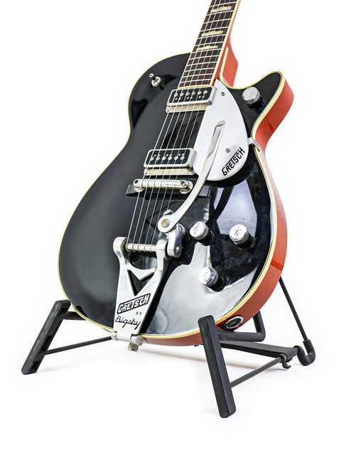 Stunning Gretsch Duo Jet 6128TSP 1957 Reissue guitar displayed on a stand, perfect for collectors and music enthusiasts.