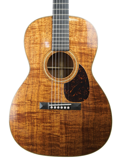 The Martin 000-28K guitar, an authentic 1921 model, highlighting its elegant body and rich wood finish, representing musical history.