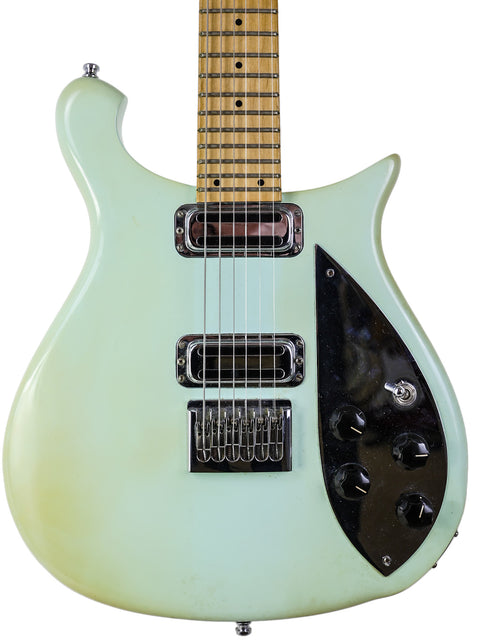 The Rickenbacker 650C Colorado electric guitar in green, made in 2005, with a bold black pickguard enhancing its design.