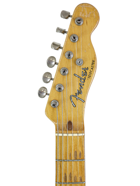 The back of a 1954 Fender Telecaster 'Blackguard', highlighting its vintage wood finish and iconic shape.