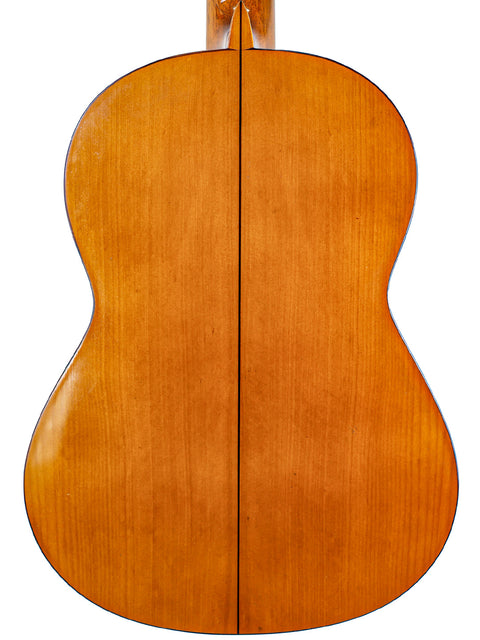 The back of an acoustic guitar with a beautiful wooden finish, marked M.G. Contreras, Calle Mayor 80, Spain, 1973.