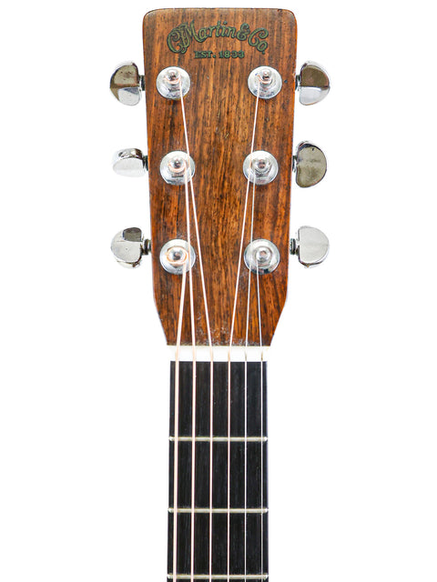 The neck of a 1974 Vintage Martin 000-28 acoustic guitar, highlighting its classic features and fine woodwork.