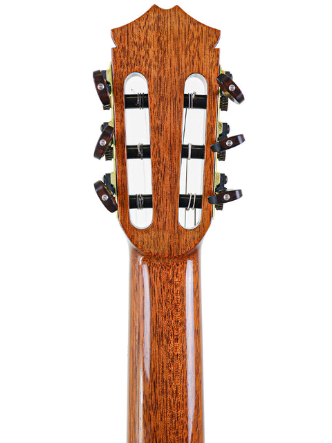 The neck of a 2002 Robin Moyes Custom acoustic guitar from Australia, featuring intricate details and a polished surface.