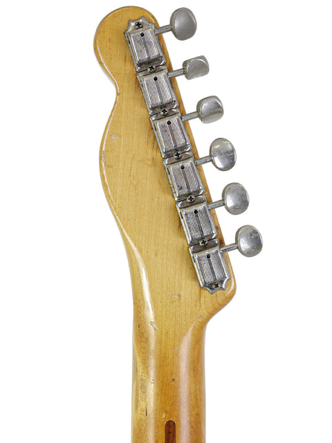 The photo captures a vintage 1954 Fender Telecaster 'Blackguard', a true classic in the world of guitars.