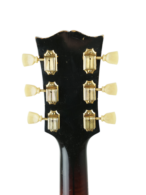 Vintage 1955 Gibson J-200 left-handed guitar headstock with a striking gold tone knob in focus.
