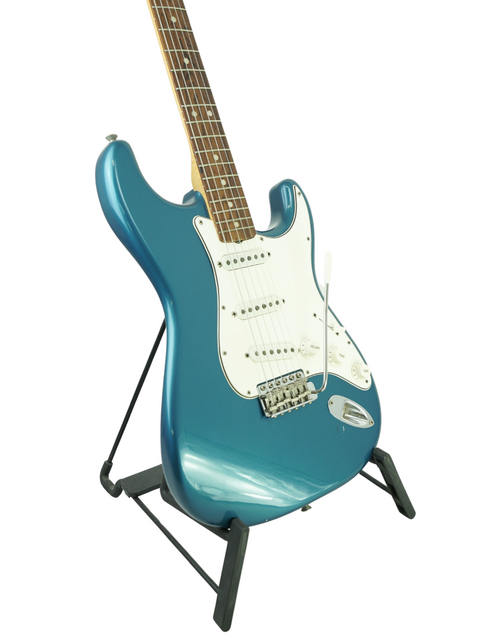 Vintage 1965 L Series Fender Stratocaster in blue, resting on a stand, showcasing its classic electric guitar design.