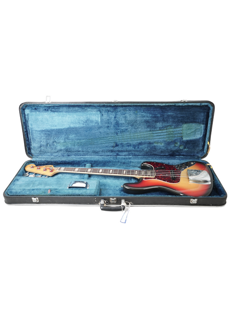 Vintage Fender Jazz Bass from 1972 in a protective case, showcased on a white surface.