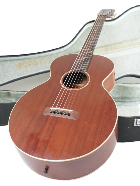 Vintage Gibson L-0 guitar from 1929, nestled in a case, featuring a beautifully crafted wooden body.