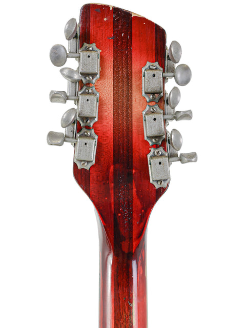 Vintage Rickenbacker 12-string guitar headstock in red, set on a clean white background, highlighting its classic design.
