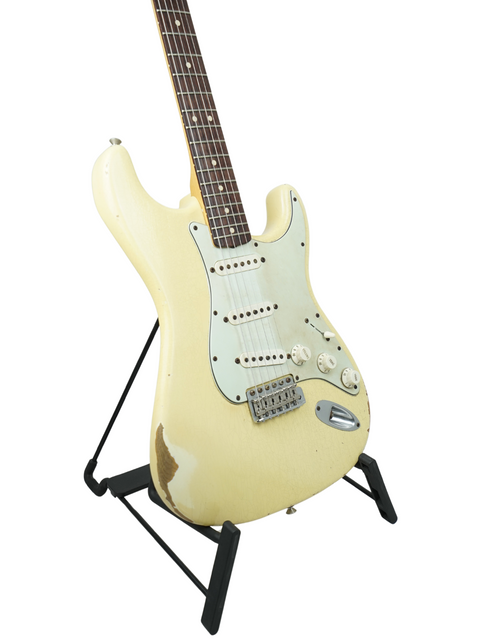 White Fender Custom Shop Limited '64 Stratocaster Relic guitar elegantly positioned on a stand with a black base.