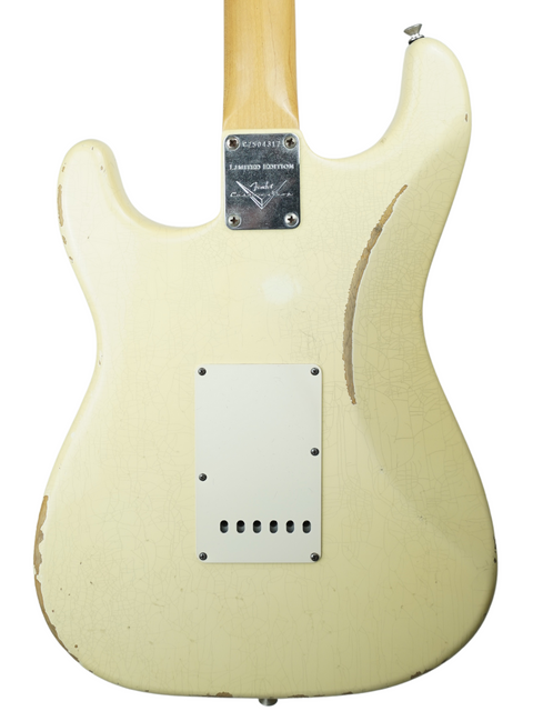 White Fender Custom Shop Limited '64 Stratocaster Relic guitar featuring a wooden body and pick guard, perfect for collectors.