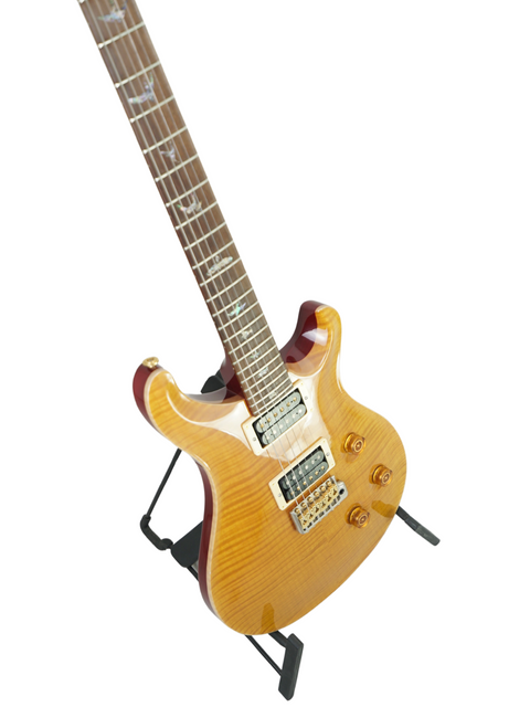 Yellow electric guitar on a stand, PRS Custom 24 Brazilian Limited 427/500, made in the USA, 2004.