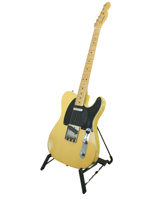 Yellow electric guitar on a stand, featuring the Fender Custom Shop Cunetto Nocaster Relic from 1998, USA-made.