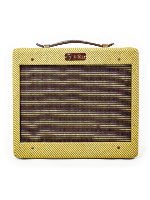 Yellow guitar amplifier, Fender Custom Shop '57 Champ Combo from 2009, featuring a brown handle for easy transport.