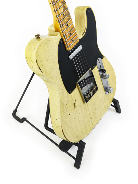 Yellow guitar with a black body and pickguard, representing the Fender Custom Shop 70th Anniversary Nocaster, USA 2020 model.