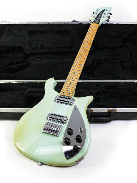 green Rickenbacker 650C Colorado electric guitar from 2005, displayed alongside its protective case.