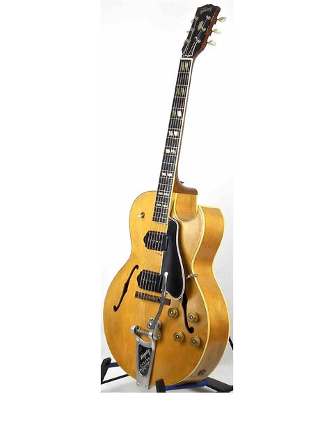 1953 Gibson ES 175 DN guitar in gold, highlighted by a black pick guard, representing timeless vintage elegance.