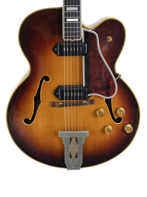 1955 Gibson L-5 CES guitar featuring a stunning sunburst finish and Alnico pickups, a true vintage masterpiece.